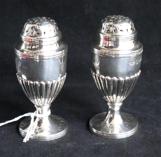 A pair of late Victorian silver pedestal pepperettes by Dobson & Sons, London, 1895 and a cased caviar spoon. 3.75in.